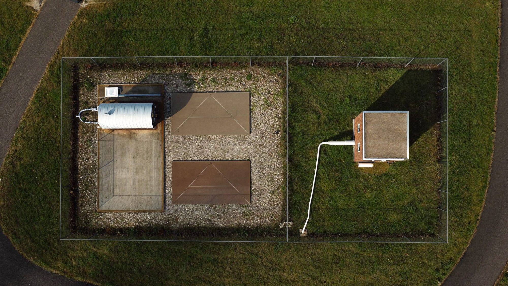 Overhead view of a sewer lift station with wet well, control cabinet and standby generator