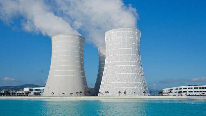 Cooling towers venting steam at dusk — illustrating water as a permitted, non-property right in the East